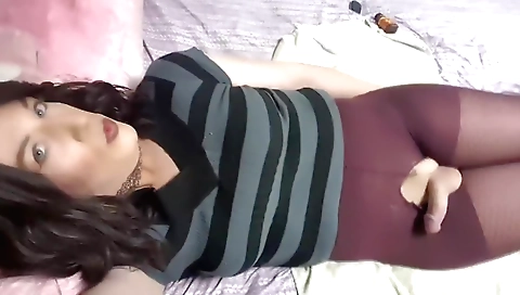 Hot brunette shemale fucks herself with a toy and masturbates