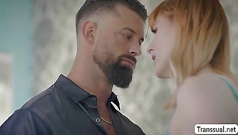 Red-haired tgirl showing off her ass in front of a black man